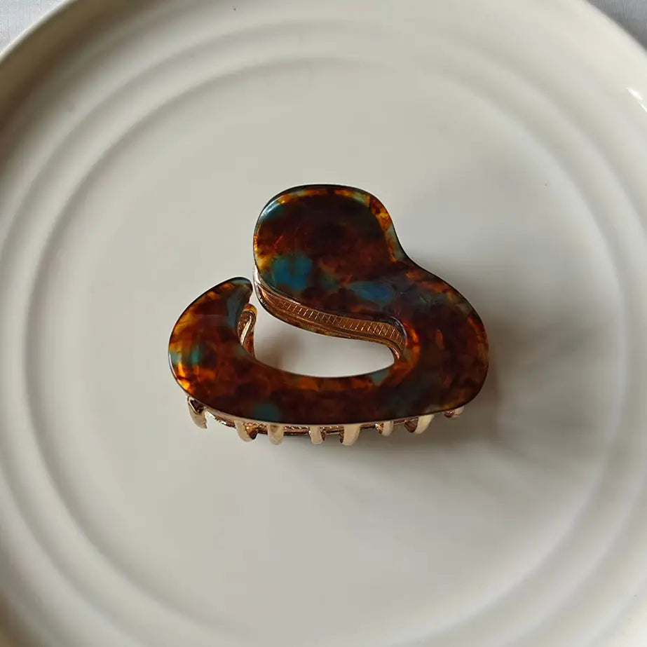  tortoiseshell hair clip on a white plate