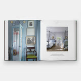 Open book showing interior design images of a bedroom and hallway.