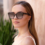 Woman wearing sunglasses with a blurred background
