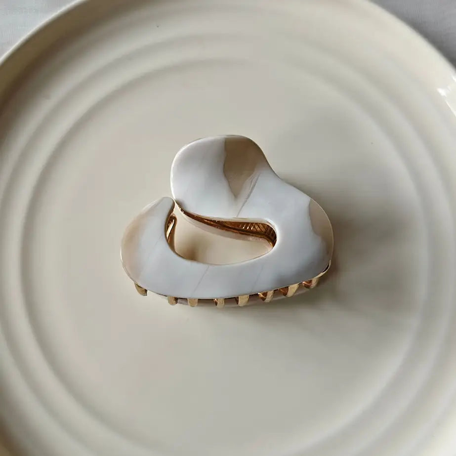 white hair claw on white plate