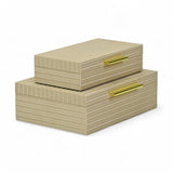 Beige striped storage boxes with gold handles on a white background