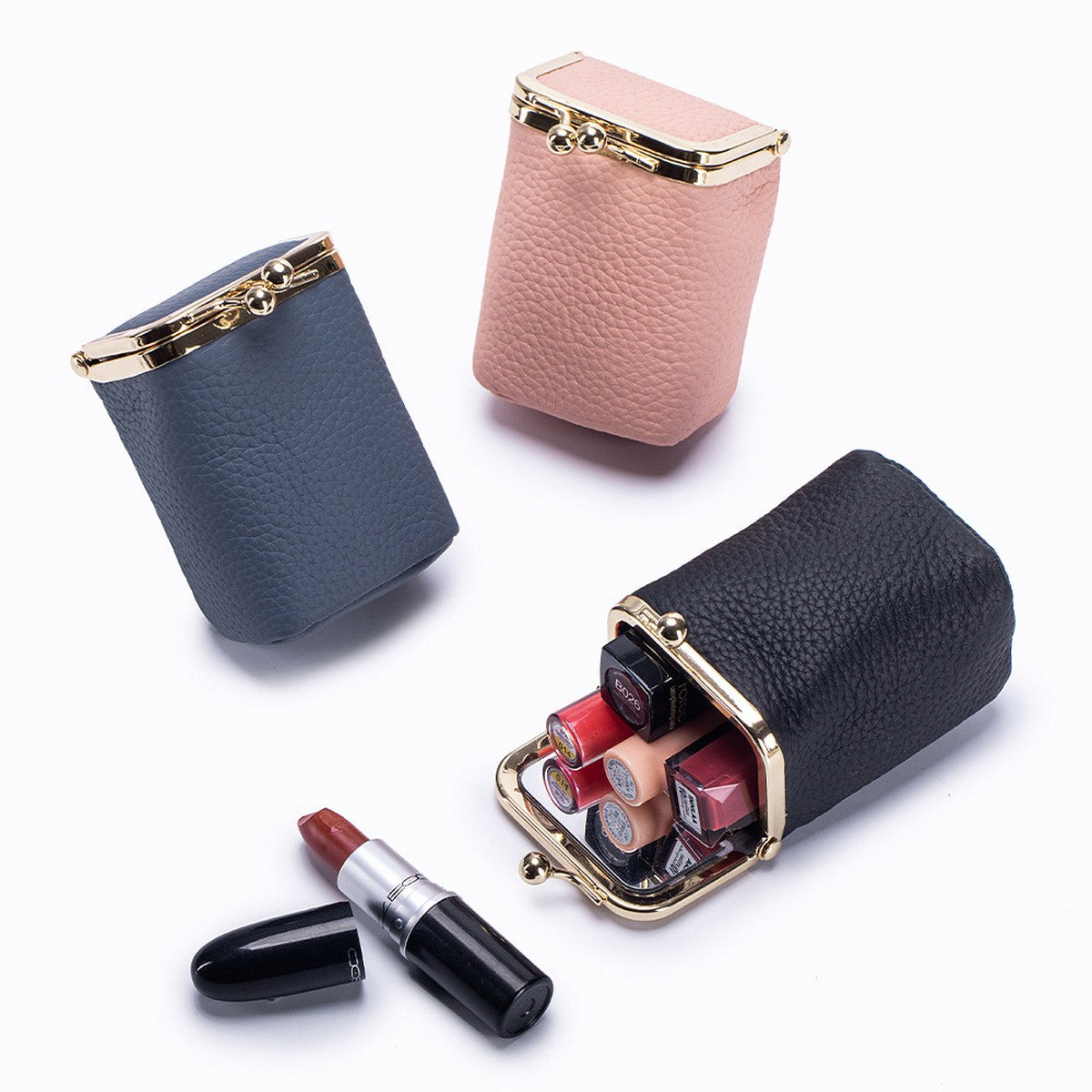 Three lipsticks in their cases on a white background