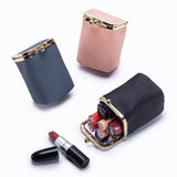 Three lipsticks in their cases on a white background