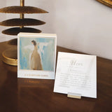 Set of scripture cards with an angel illustration on a wooden surface