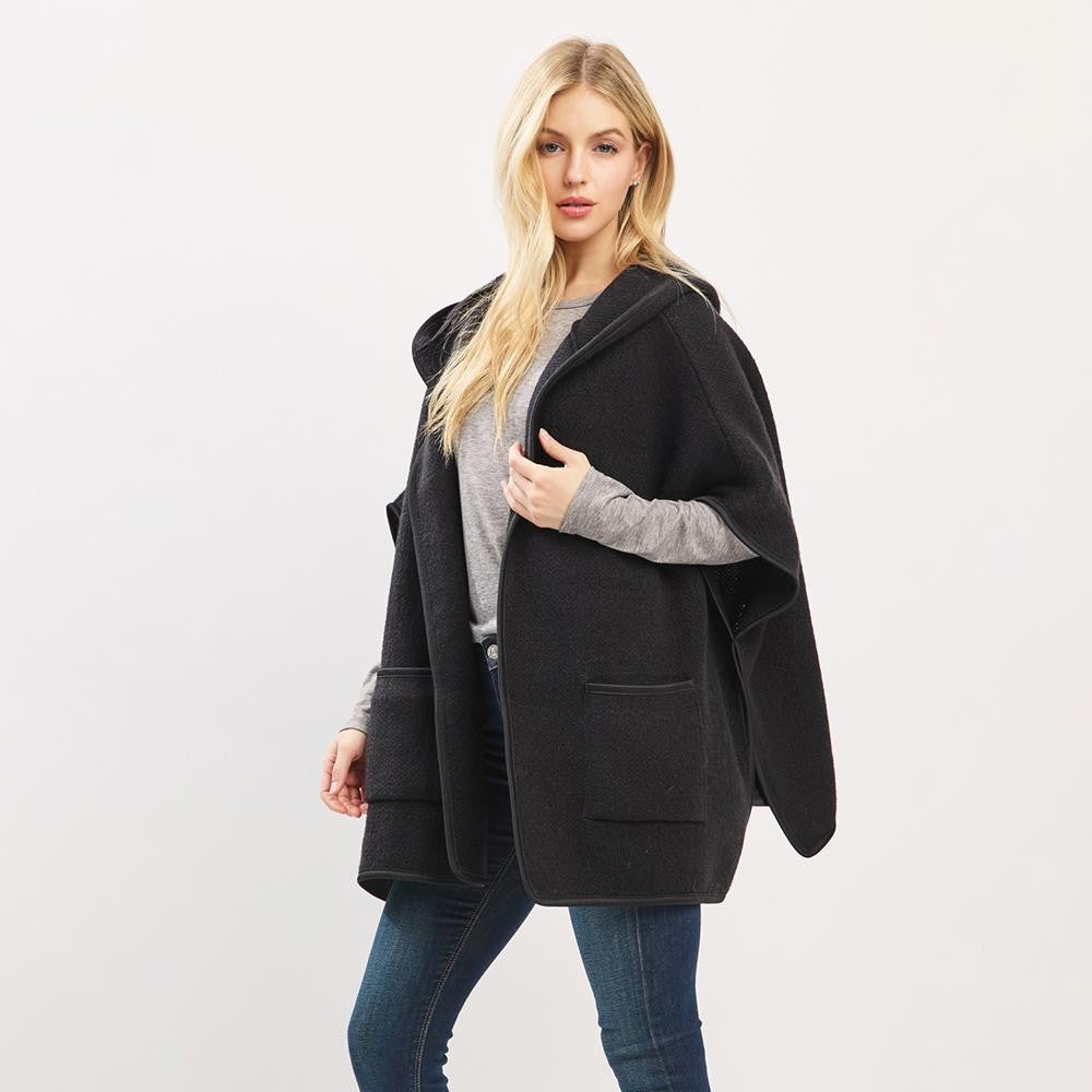 Woman wearing a black hooded coat on a white background