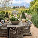 Outdoor patio set with table and chairs in a garden setting