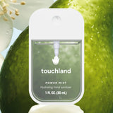 Touchland power mist hand sanitizer packaging with a green background