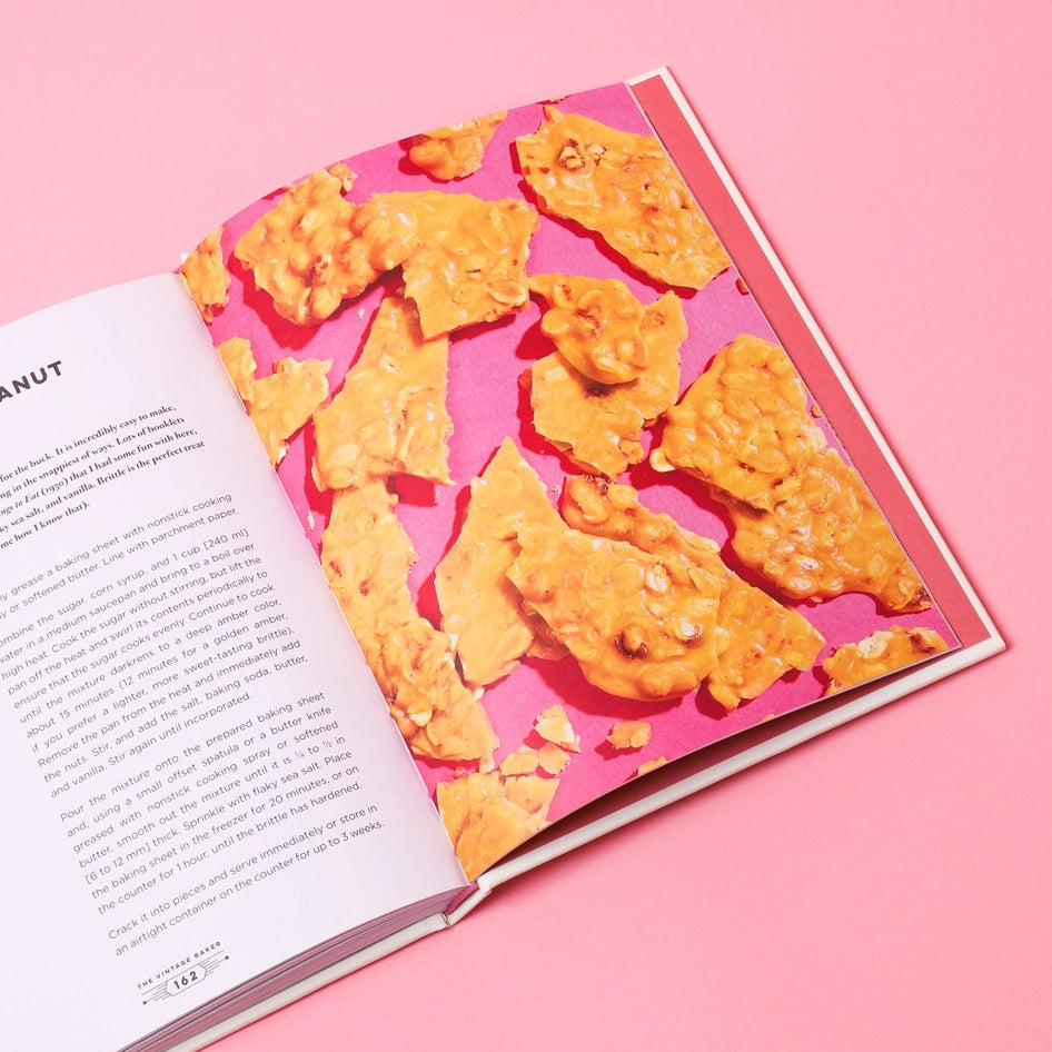 Book with a pink cover featuring a pattern of orange snacks on a pink background
