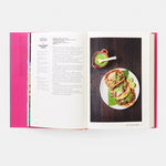 Open cookbook showing a page with a recipe and an image of tacos with guacamole and limes.