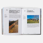 Open book showing pages about vineyards with images of landscapes.