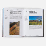 Open book showing pages about vineyards with images of landscapes.