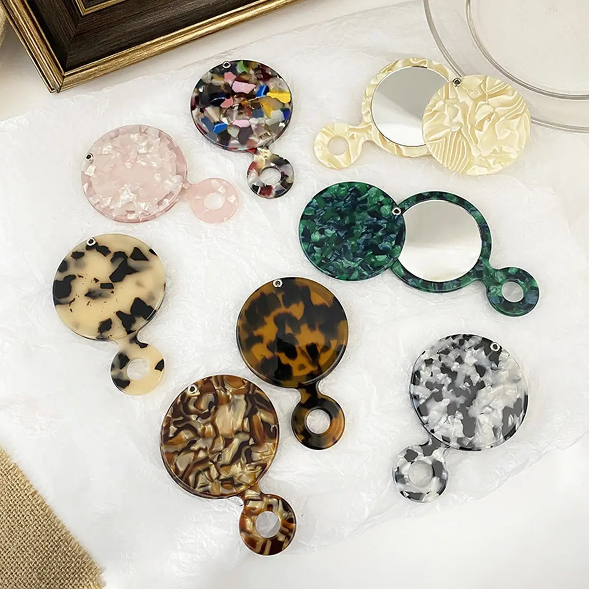 Collection of variously patterned round mirrors on a white surface