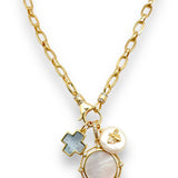 Gold necklace with various charms on a white background