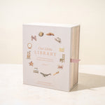 Book titled 'Our Little Library' with decorative illustrations on a white background