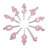 Pink number candles arranged in a circular pattern on a white background