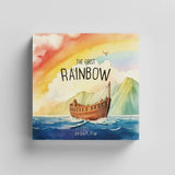 Book cover of 'The First Rainbow' by Jordon P. Frye with a colorful illustration of a rainbow, boat, and mountains.