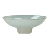 glazed ceramic wide flared  pedestal bowl with ribbed textured base on white background