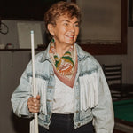Woman holding a pool cue in a casual setting