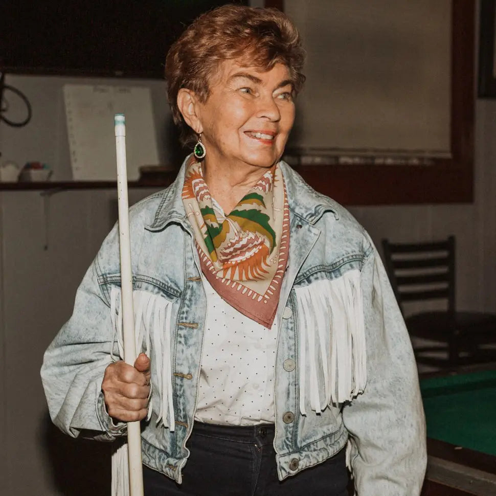 Woman holding a pool cue in a casual setting