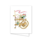 Birthday card with a gold cart illustration and flowers on a white background