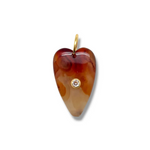 Heart-shaped amber pendant with a diamond on a white background