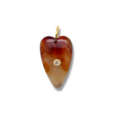 Heart-shaped amber pendant with a diamond on a white background