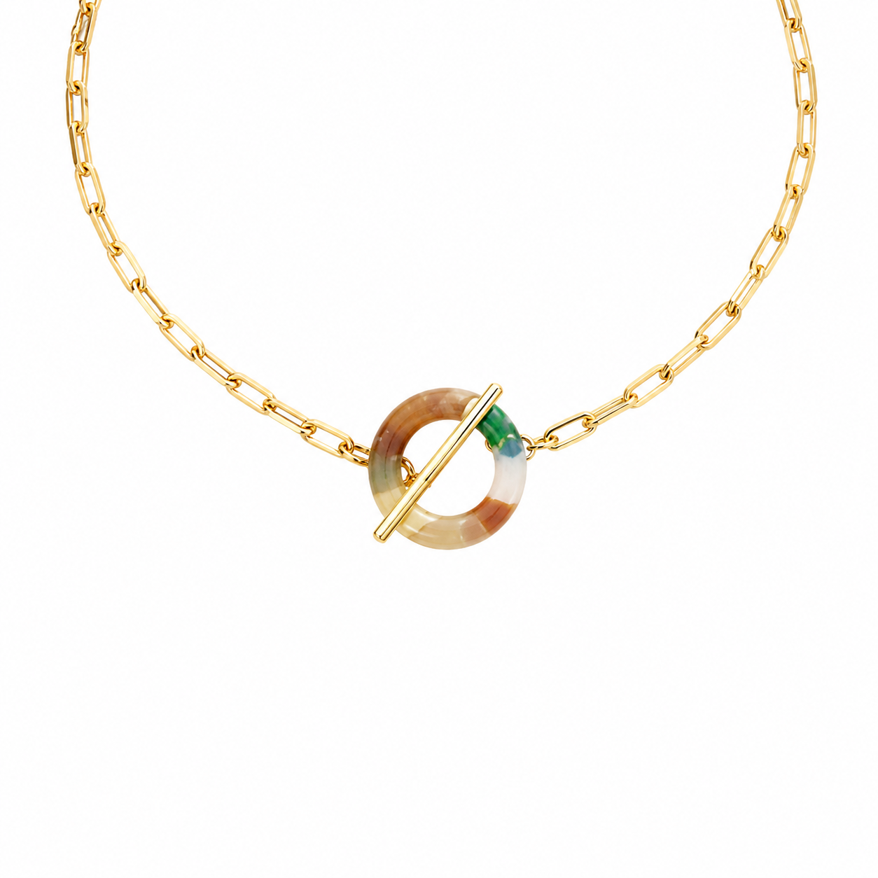 A gold chain necklace featuring a circular toggle clasp with a marbled beige and brown resin center and a small green accent.