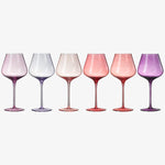Set of six wine glasses with gradient colors on a white background