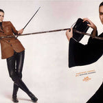 Two women in leather outfits with accessories on a white background