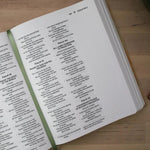 Open bible with text on a wooden surface