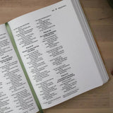 Open bible with text on a wooden surface