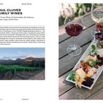 Magazine spread featuring Paul Cluver Family Wines with wine glasses, food platter, and vineyard photo.