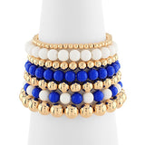Set of beaded bracelets in gold, blue, and white on a white background