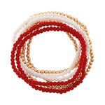 Set of red, white, and gold beaded bracelets on a white background