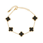 gold chain bracelet with five clover-shaped black enamel charms