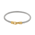 Silver cable bracelet with a gold clasp on a white background