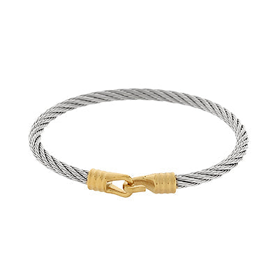 Silver cable bracelet with a gold clasp on a white background