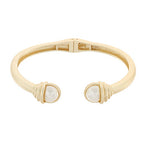 gold hinged cuff bracelet with two pearl like ends accented by wrapped gold detail
