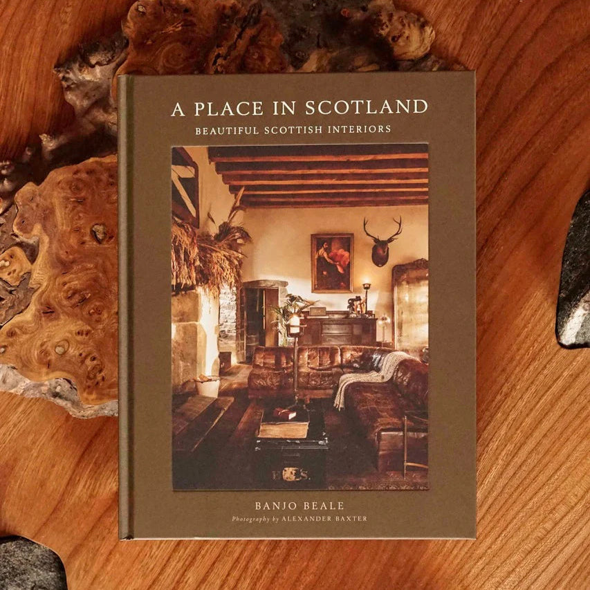Book titled 'A Place in Scotland' on a wooden surface