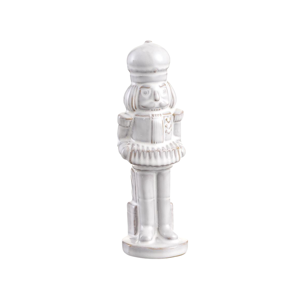White ceramic nutcracker figurine on a white background