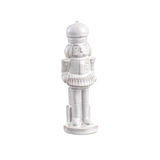 White ceramic nutcracker figurine on a white background