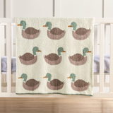 chenille blanket with mallard ducks hanging on a baby crib
