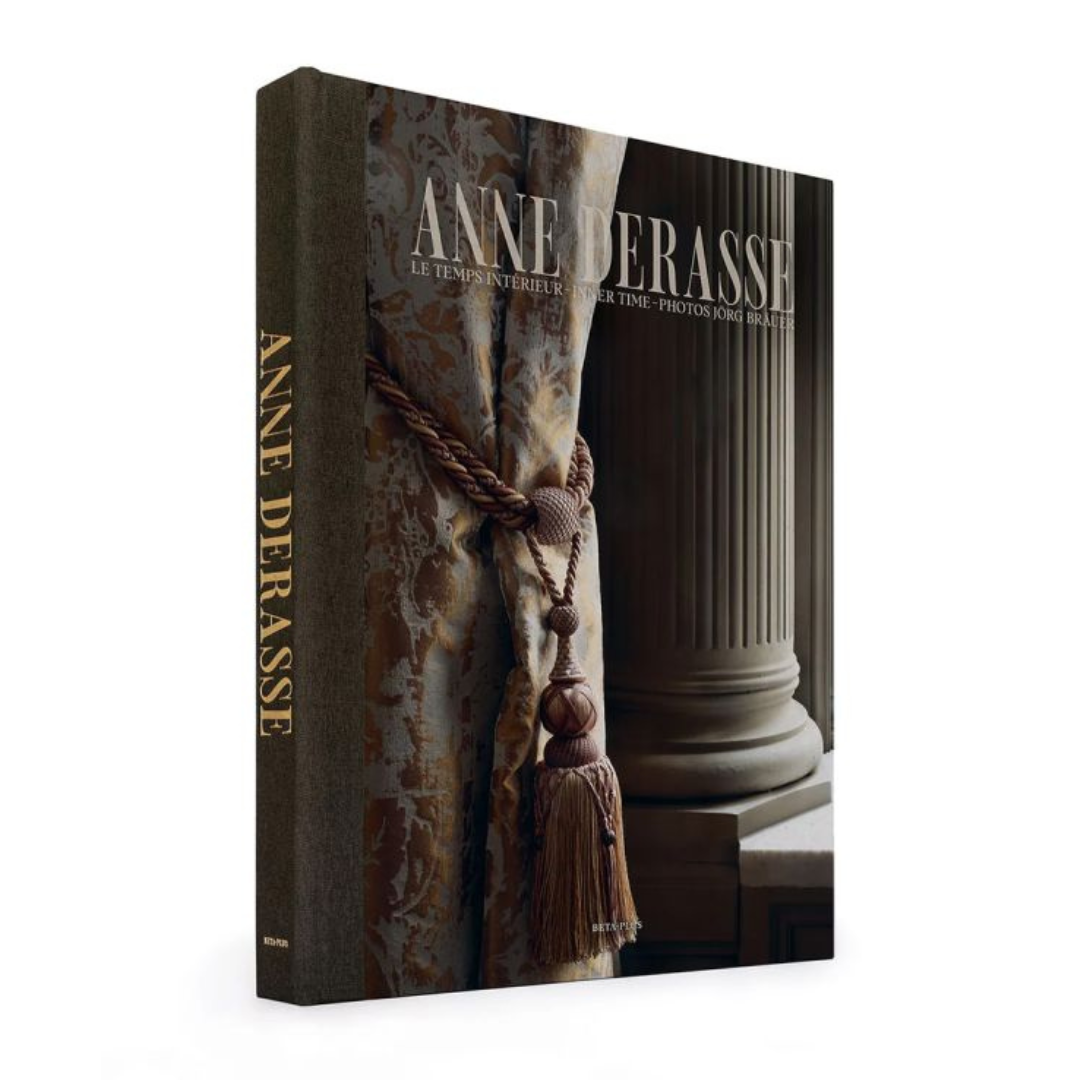 HARDCOVER COFFEE TABLE BOOK ANNE DERASSE ON A WHITE BACKGROUND