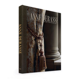 HARDCOVER COFFEE TABLE BOOK ANNE DERASSE ON A WHITE BACKGROUND