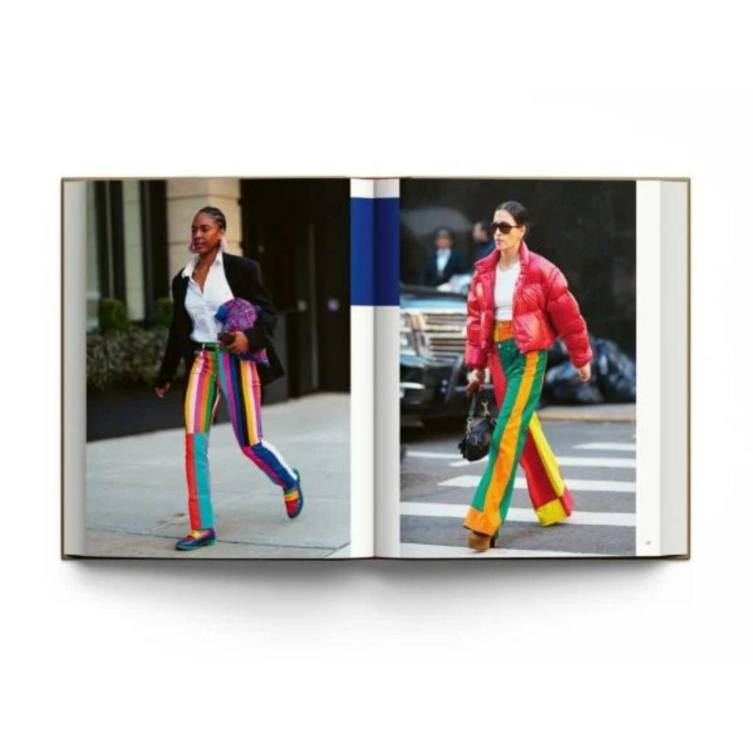 open page view of two women showing their street style from the hardcover book "New York. In Fashion" on a white background