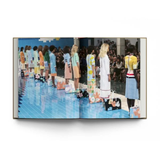 open page view of a fashion runway showing from the hardcover book "New York. In Fashion" on a white background