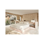 image of A modern platform bed with a built-in headboard and side tables, styled in a minimalist light wood bedroom with a large window overlooking a rock garden from the hardcover book "world's best: 50 interiors from around the globe" on a white background
