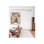 Contemporary Living Yearbook 2026 book cover featuring a modern living room scene with a wooden sculptural coffee table, abstract wall art, a floor lamp, and a speaker against a white wall.
