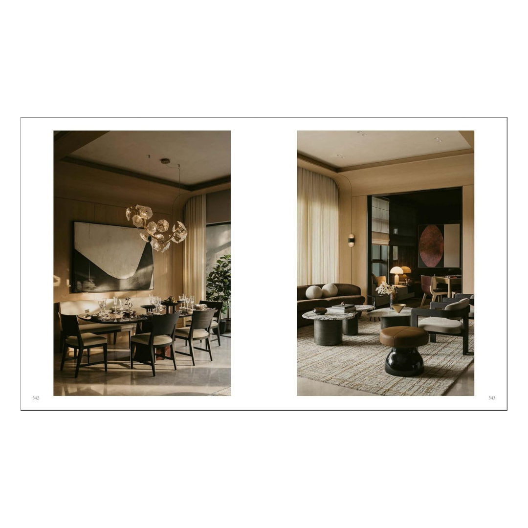 A two-page interior design spread showing a dining room on the left and a living room on the right, styled in warm neutral tones with beige, brown, black, and cream furnishings from the hardcover book "contemporary living yearkbook 2026"