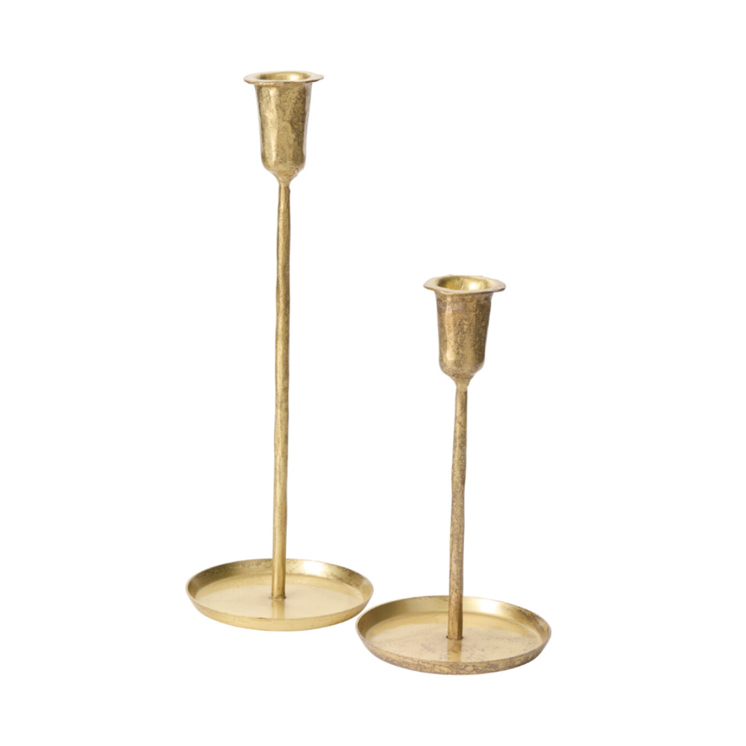 two thin gold candlesticks with low rim base, available in varying heights, on a white background